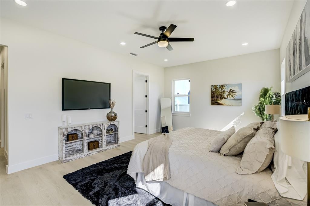319 Cedar Lane Largo, FL 33770 - Photo 19 of 37 a bedroom with a bed and a flat screen tv