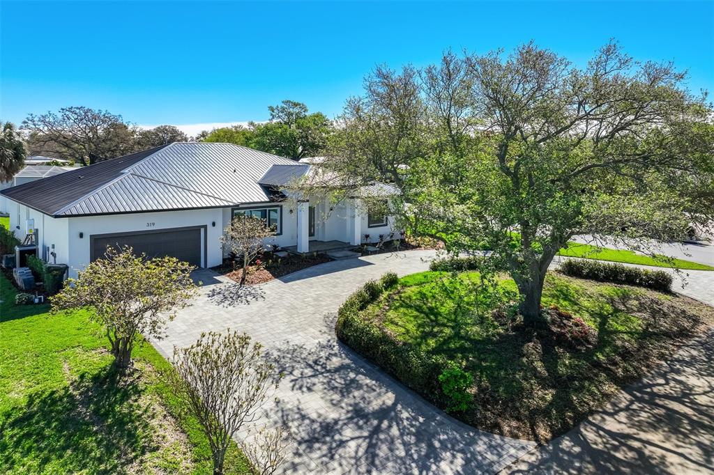 319 Cedar Lane Largo, FL 33770 - Photo 2 of 37 a view of a house with a yard and garden