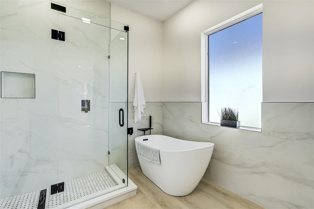 319 Cedar Lane Largo, FL 33770 - Photo 24 of 37 a bathroom with a bathtub and shower