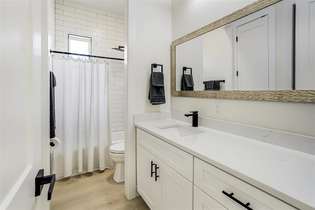 319 Cedar Lane Largo, FL 33770 - Photo 27 of 37 a bathroom with a sink and a mirror