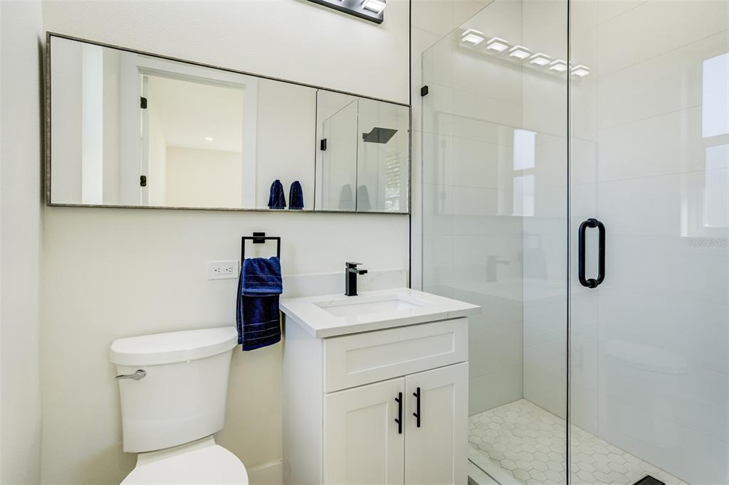 319 Cedar Lane Largo, FL 33770 - Photo 30 of 37 a bathroom with a sink a toilet and shower