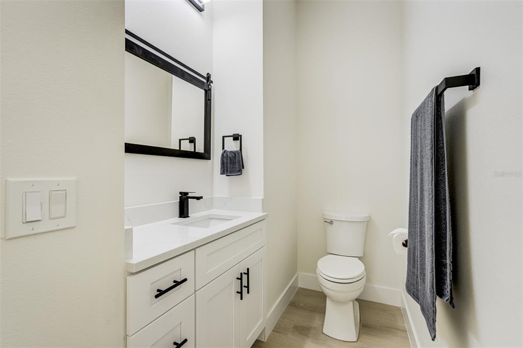319 Cedar Lane Largo, FL 33770 - Photo 31 of 37 a bathroom with a toilet sink and mirror