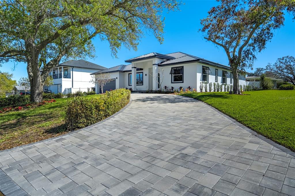 319 Cedar Lane Largo, FL 33770 - Photo 33 of 37 a front view of a house with a yard and garage