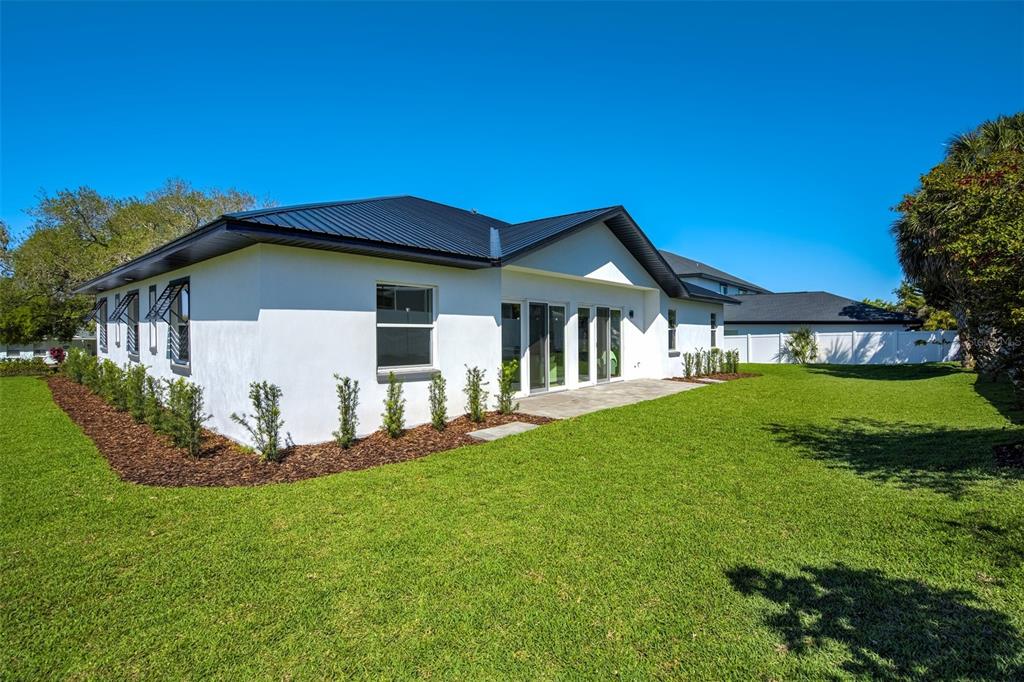 319 Cedar Lane Largo, FL 33770 - Photo 35 of 37 a front view of a house with a yard