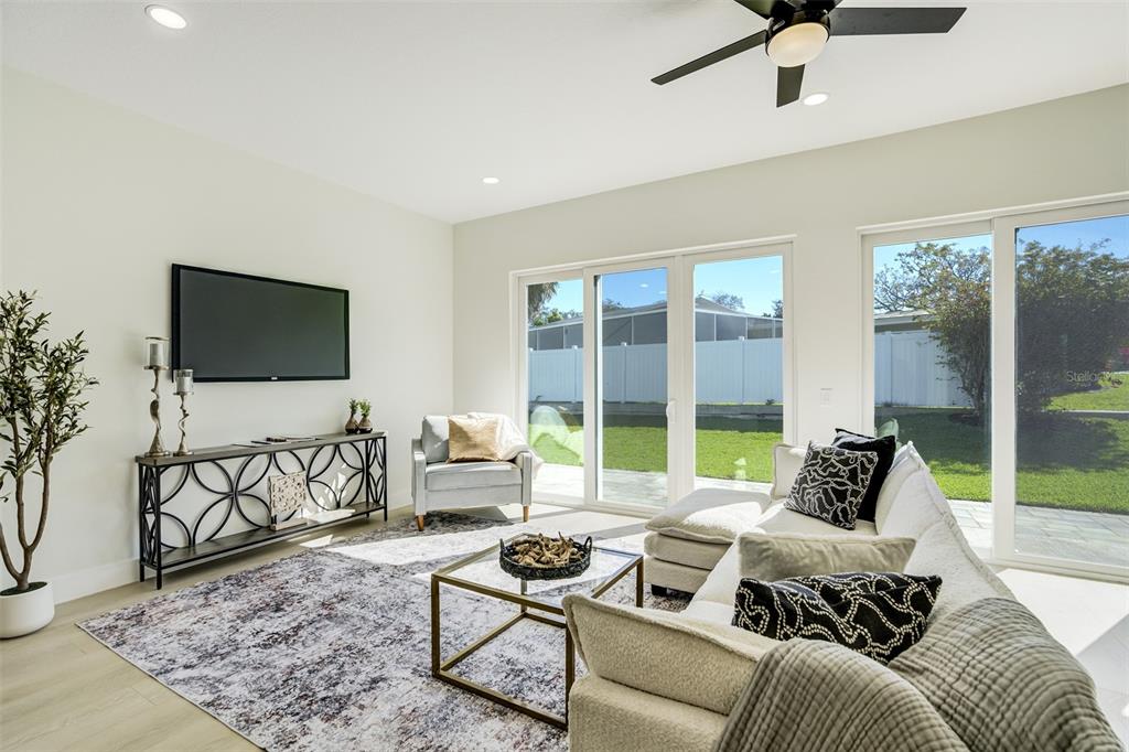 319 Cedar Lane Largo, FL 33770 - Photo 6 of 37 a living room with furniture and a flat screen tv
