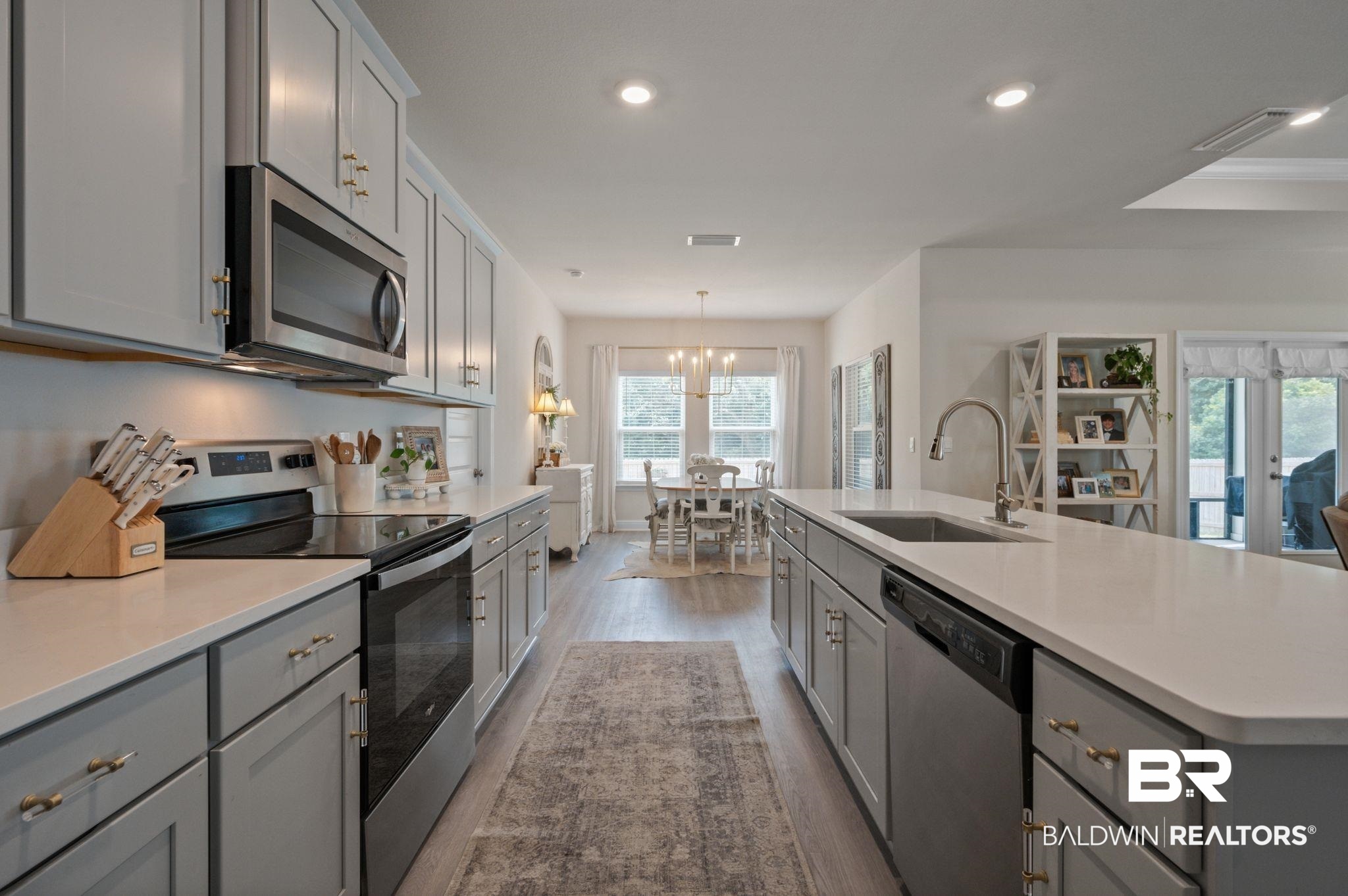 681 Calibre Street Fairhope, AL 36532 - Photo 18 of 56 Kitchen with light hardwood / wood-style flooring, stainless steel appliances, sink, and a healthy amount of sunlight