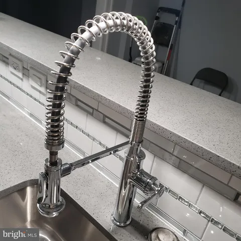 a kitchen with a sink and a mirror