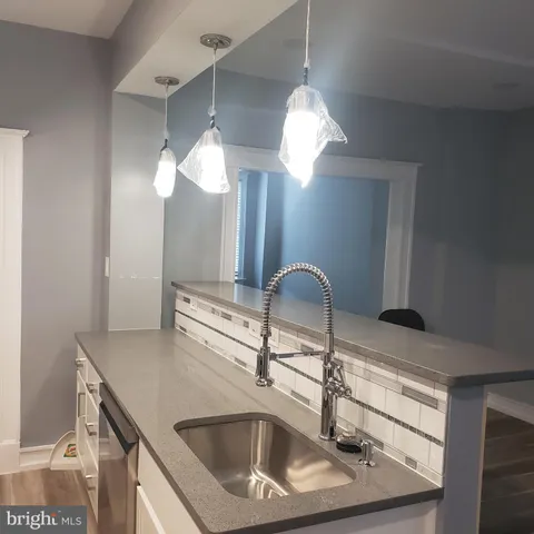 a view of a small space with wooden floor and a window