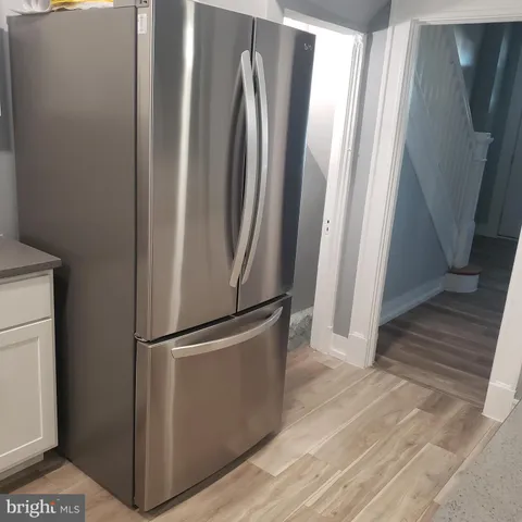 a white toilet sitting next to a shower