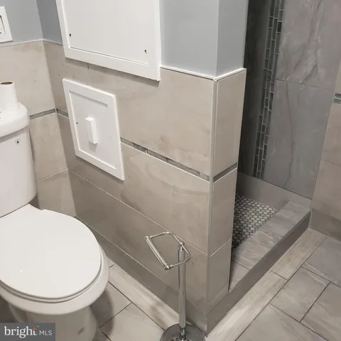 a bathroom with a sink toilet and mirror