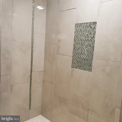 a view of a small space with wooden floor and a window