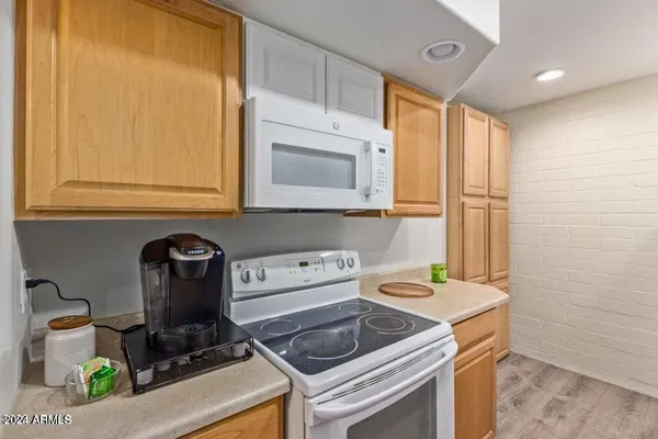 a kitchen with stainless steel appliances a sink a stove and a refrigerator with wooden floor