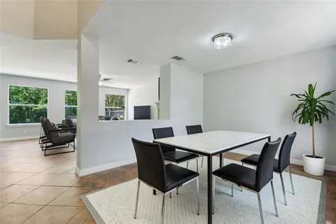a view of a dining room with furniture and a potted plant
