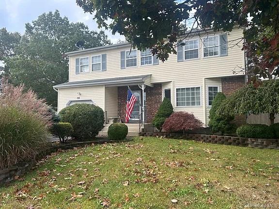 118 Lexington Road Shirley, NY 11967 - Photo 1 of 1 Traditional-style home with a front yard and brick siding