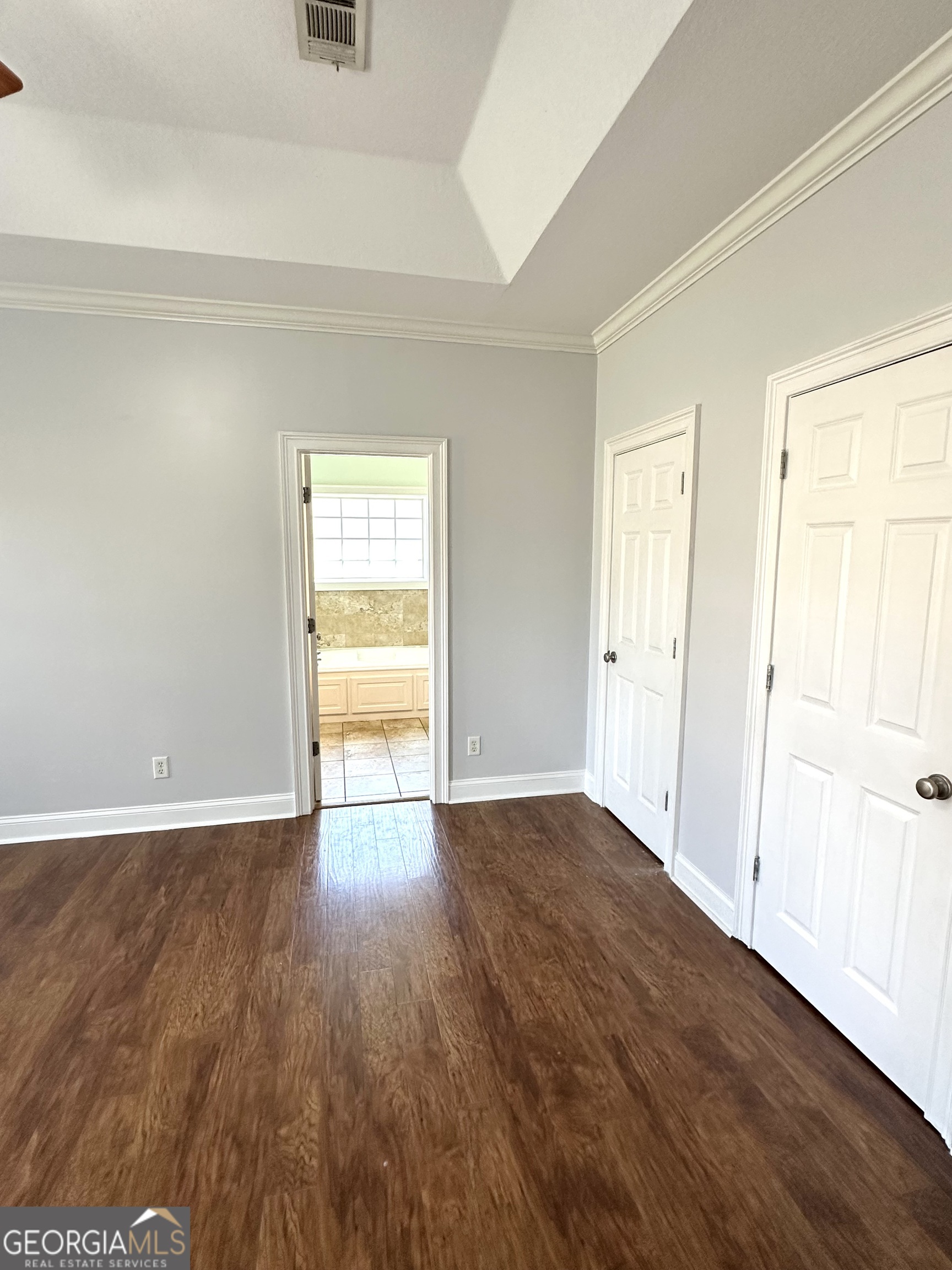 26 Alan Lane Tifton, GA 31793 - Photo 13 of 28 an empty room with wooden floor and windows