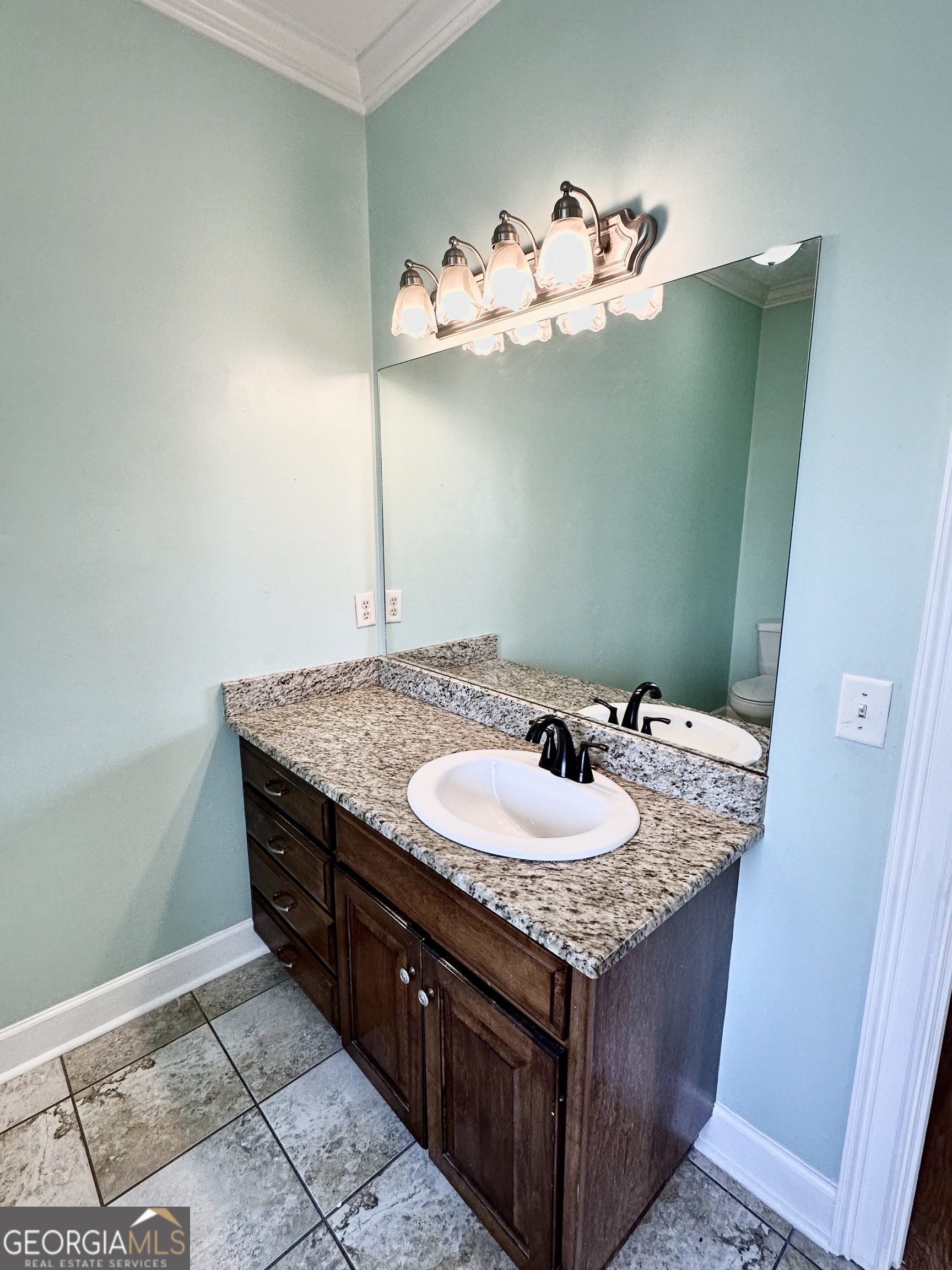 26 Alan Lane Tifton, GA 31793 - Photo 14 of 28 a bathroom with a sink vanity and a mirror