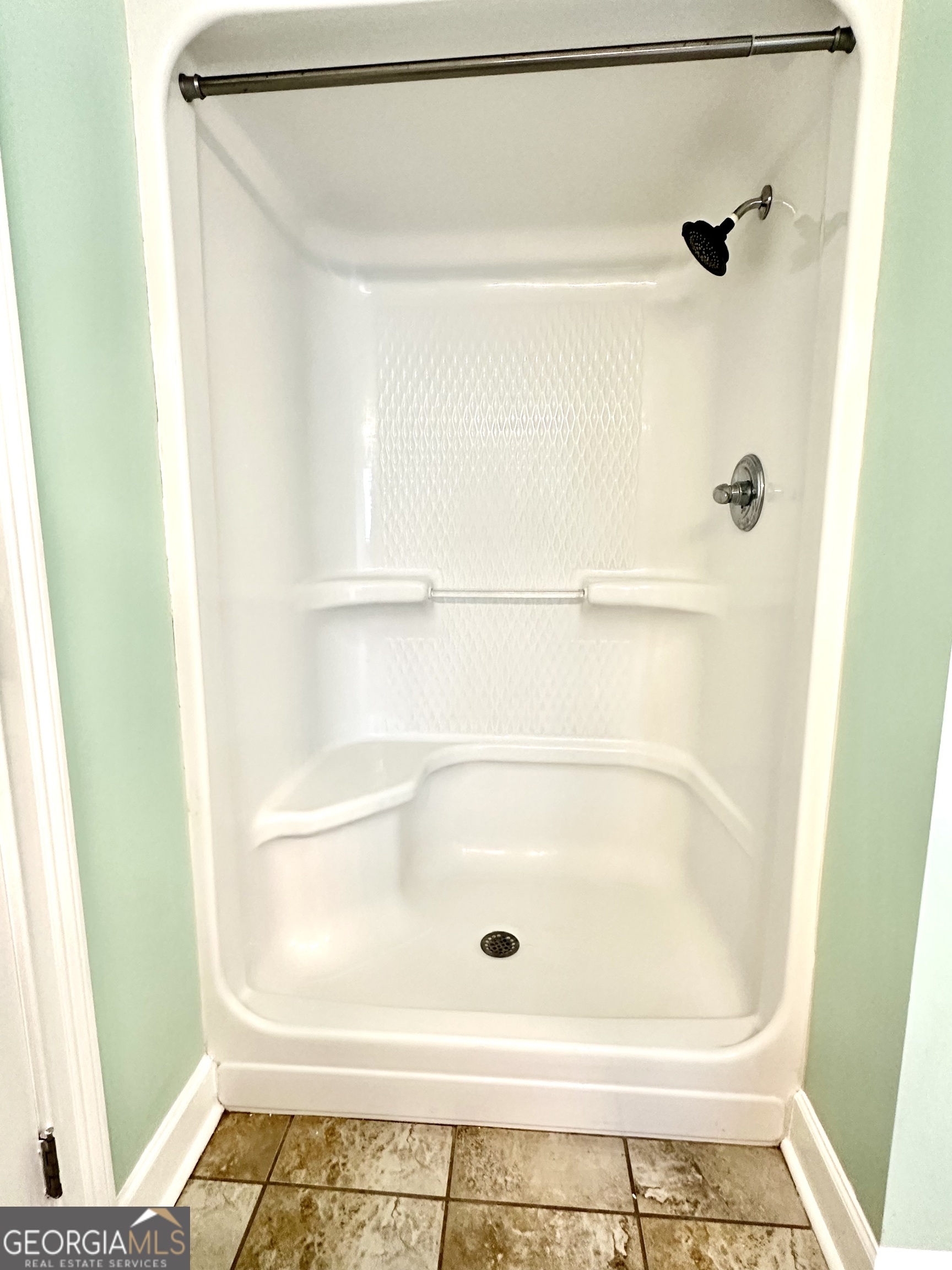 26 Alan Lane Tifton, GA 31793 - Photo 17 of 28 a bathroom with a glass shower door