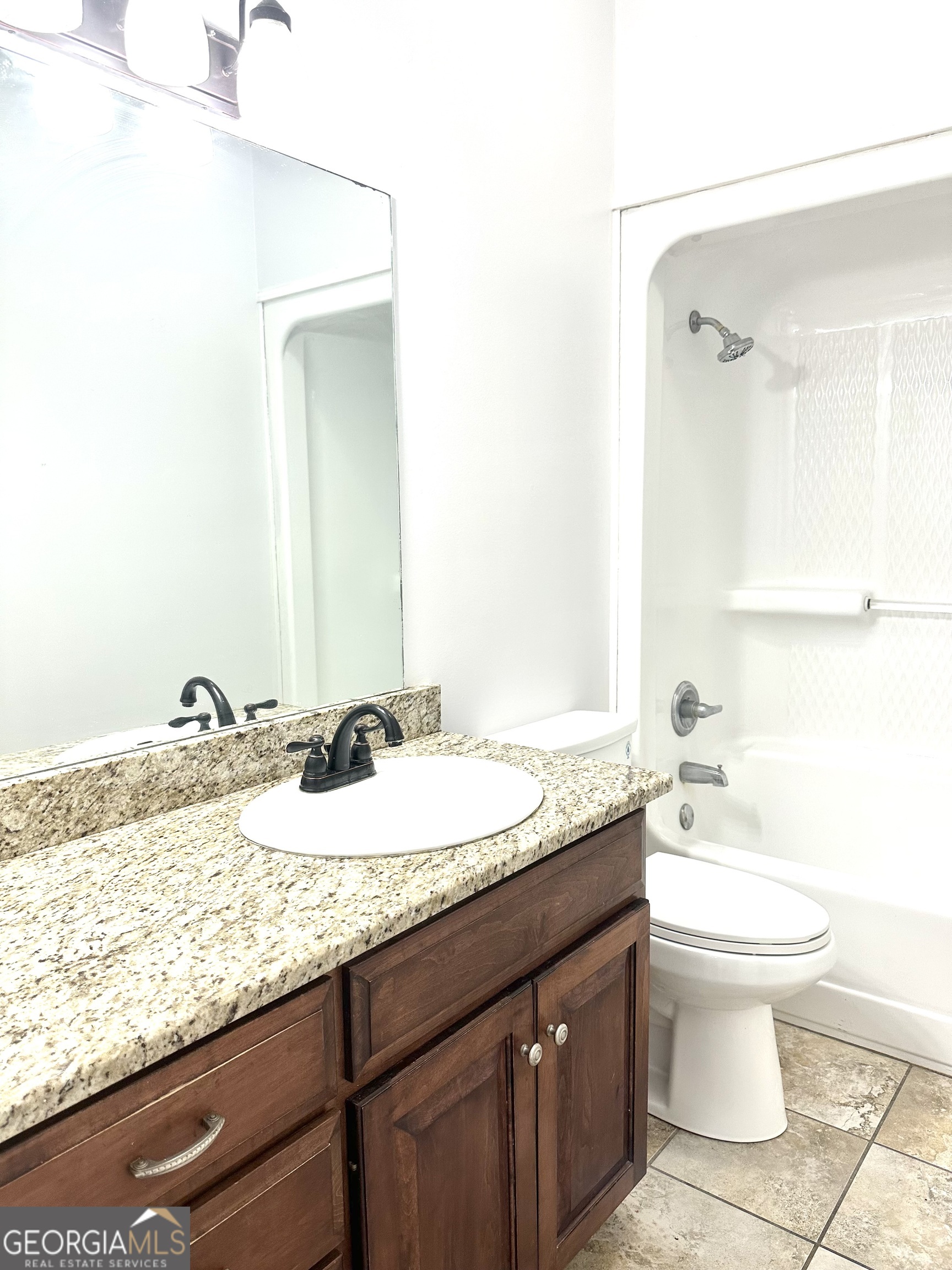 26 Alan Lane Tifton, GA 31793 - Photo 22 of 28 a bathroom with a granite countertop sink and a mirror