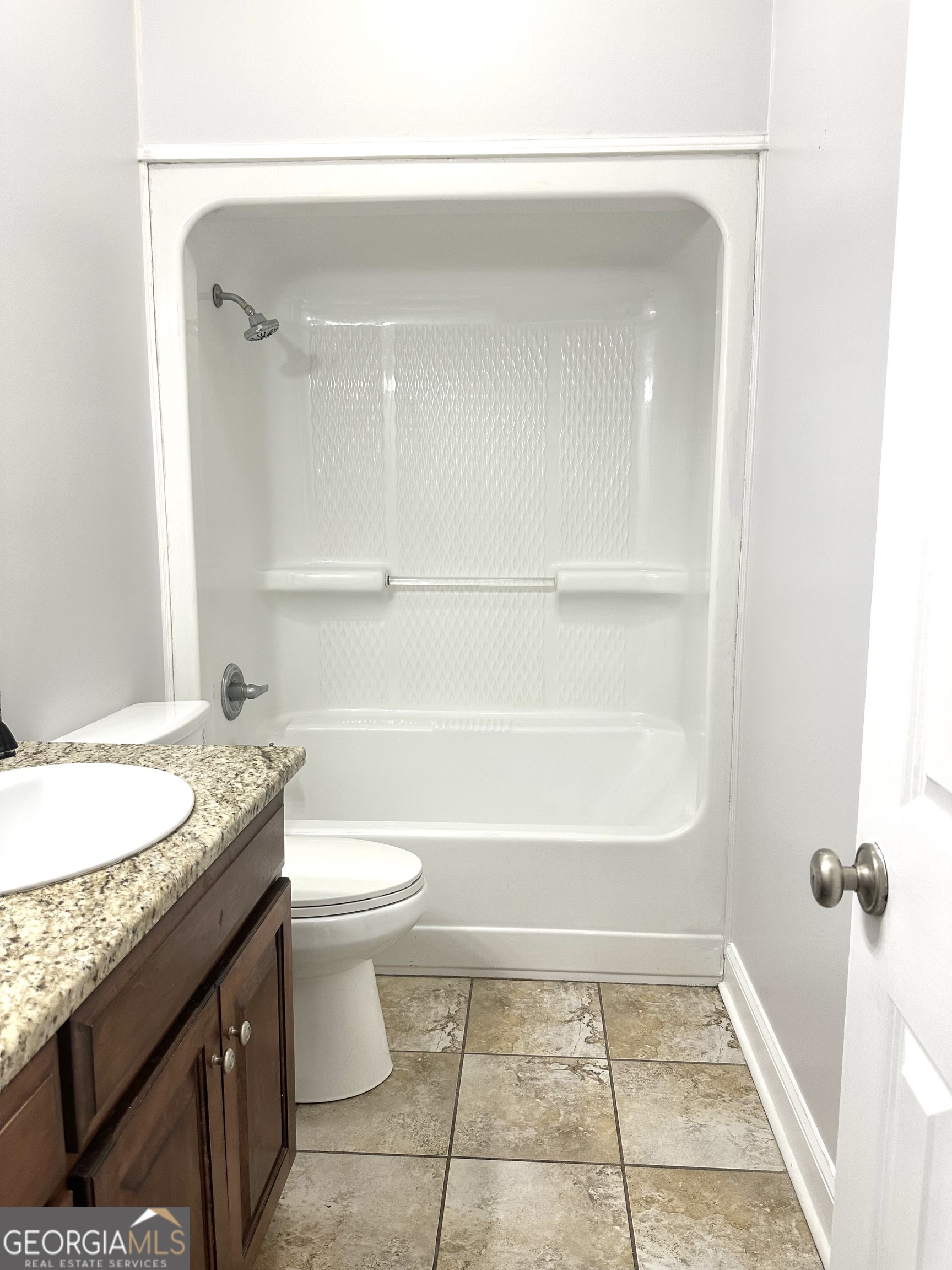 26 Alan Lane Tifton, GA 31793 - Photo 23 of 28 a bathroom with a granite countertop sink toilet and shower