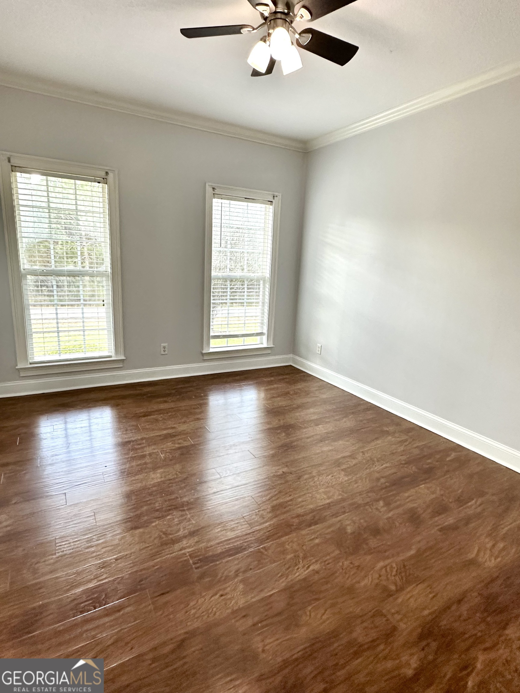 26 Alan Lane Tifton, GA 31793 - Photo 7 of 28 an empty room with wooden floor and windows