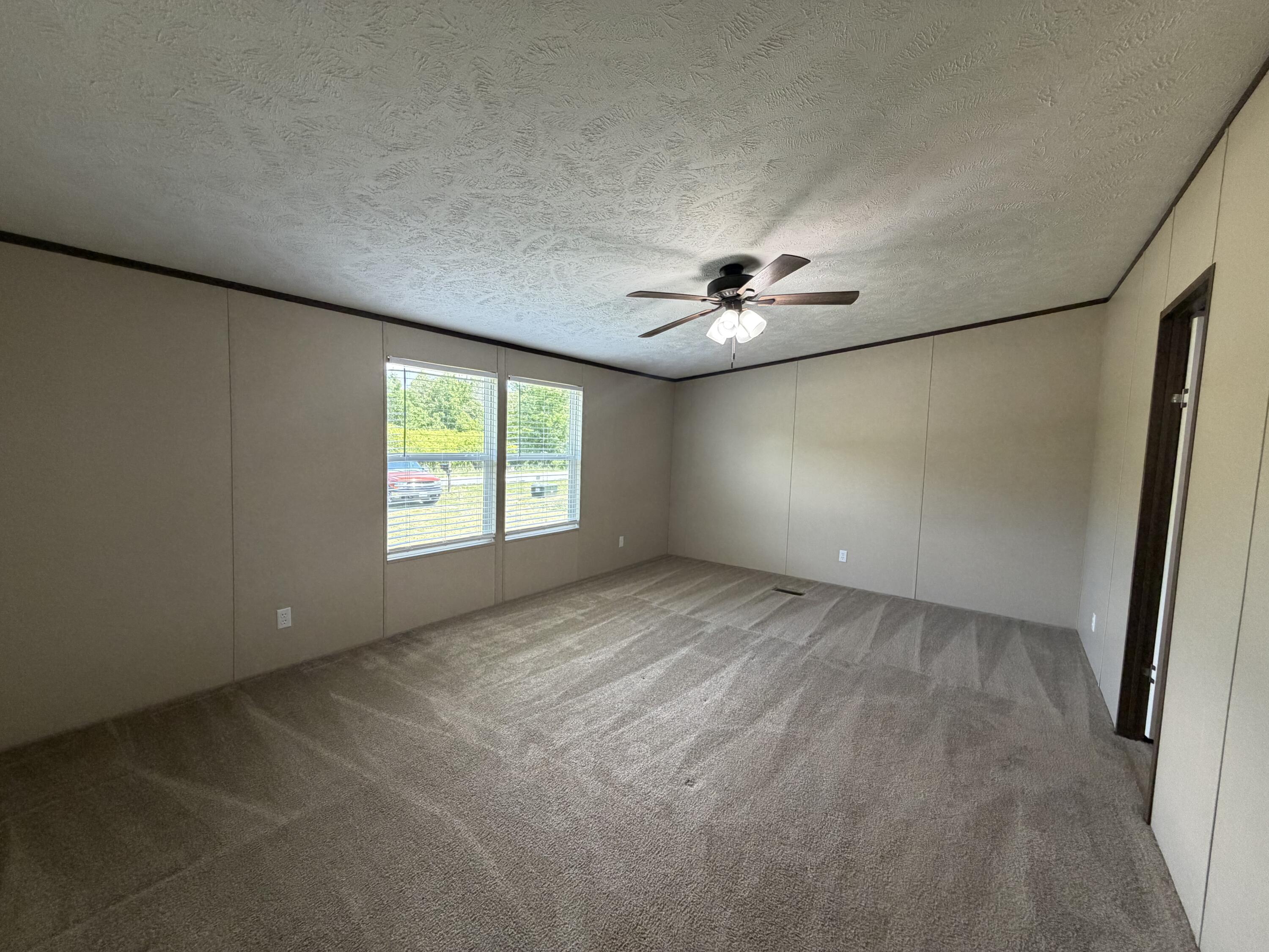 1644 Gap Road Chatham, VA 24531 - Photo 8 of 15 an empty room with windows and chandelier fan