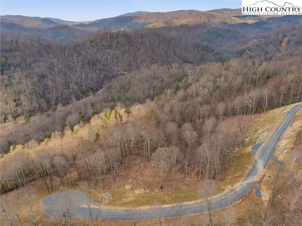 a view of a house with garden and a sitting area