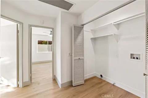 an empty room with wooden floor and closet