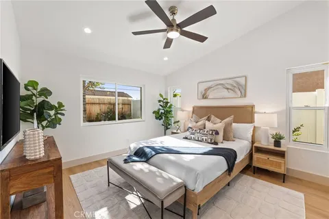 a bedroom with a bed and a potted plant