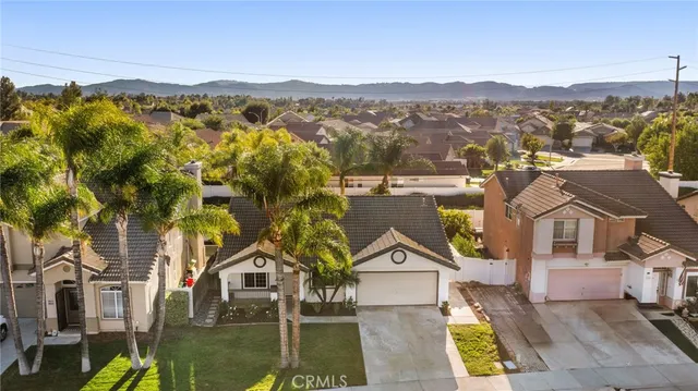 an aerial view of residential houses with outdoor space and ocean view