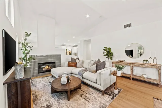 a living room with furniture a fireplace and a flat screen tv