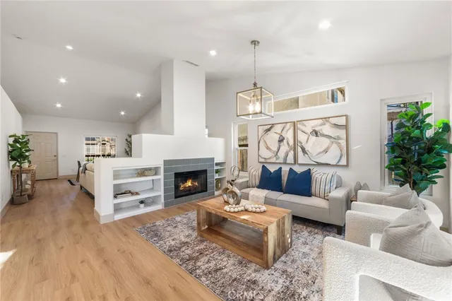 a living room with furniture fireplace and a table