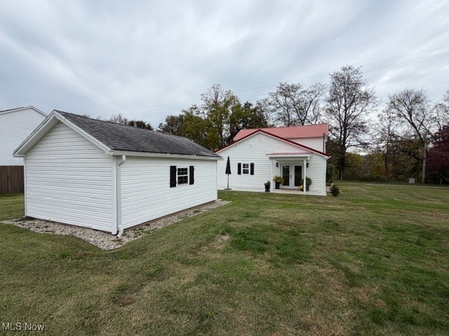 1097 Old River Road Boaz, WV 26187 - Photo 21 of 21 Back of house featuring a yard, an outdoor structure, and a patio area