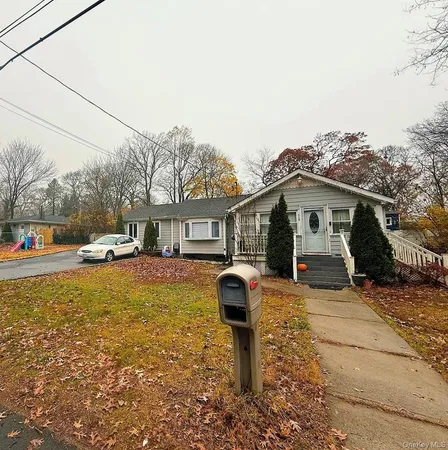 a front view of a house with a yard covered in snow