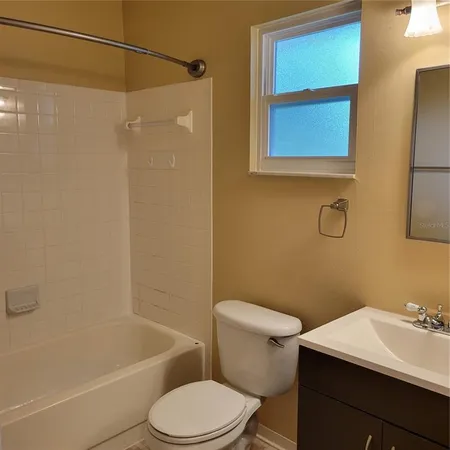 a bathroom with a toilet a sink and shower