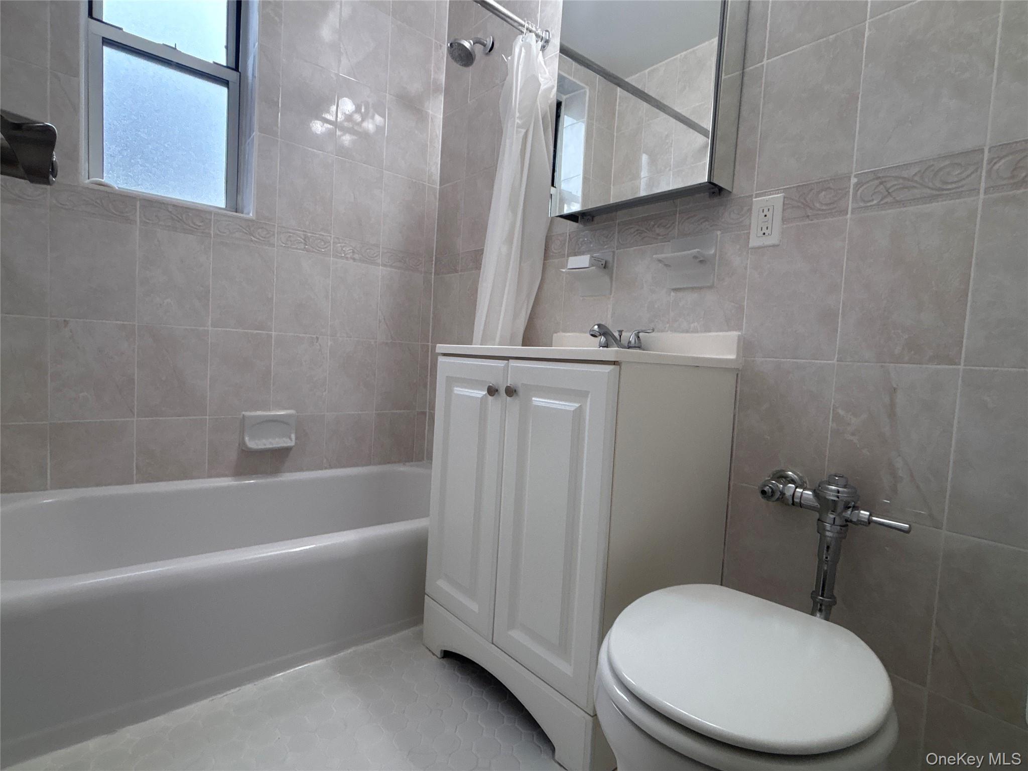 50 South Middle Neck Road, Unit 2L Great Neck, NY 11021 - Photo 7 of 12 a white toilet sitting next to a bathtub