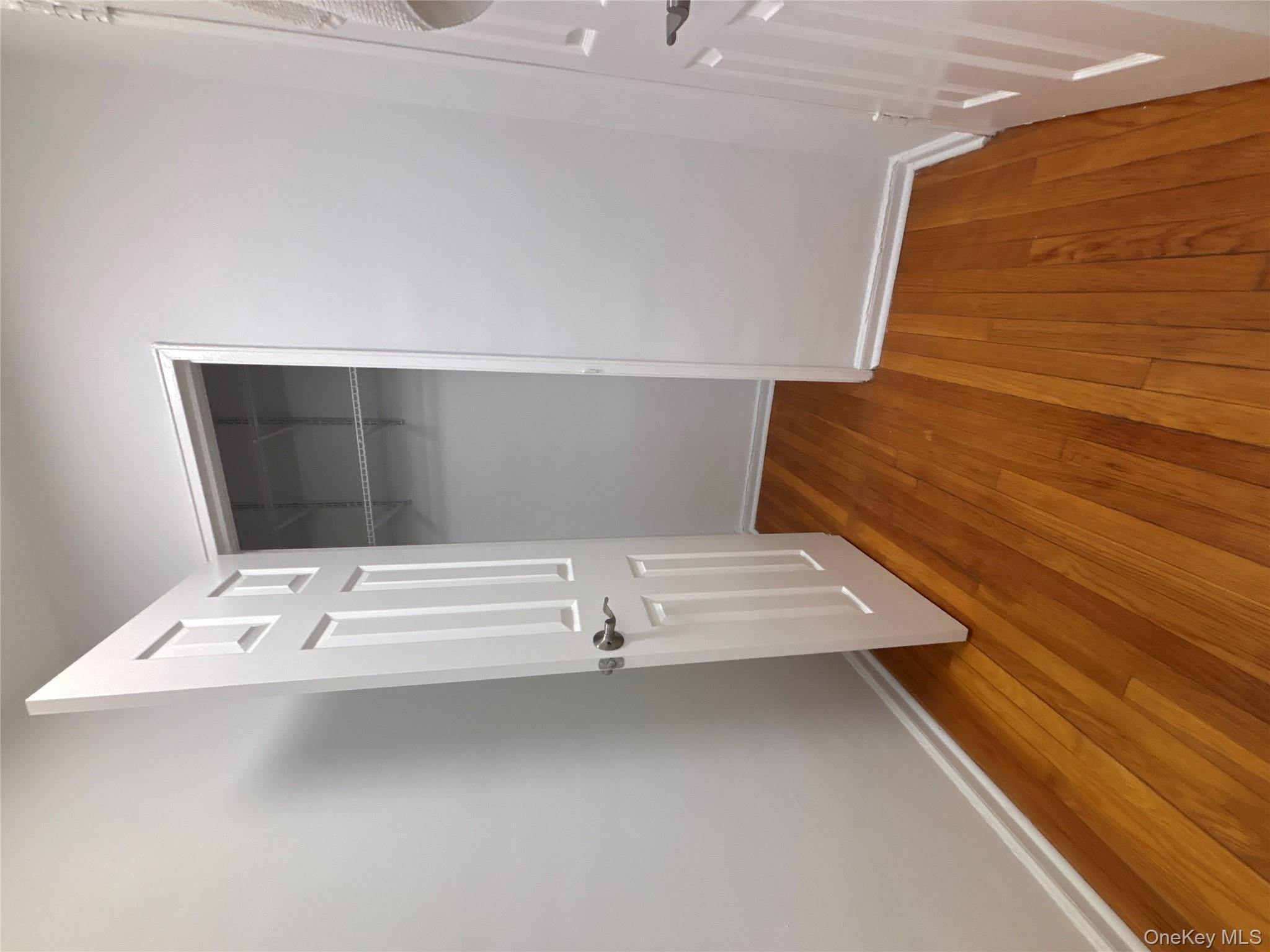 50 South Middle Neck Road, Unit 2L Great Neck, NY 11021 - Photo 8 of 12 an empty room with wooden floor and entrance