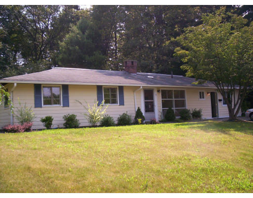 79 Rindone Street Holbrook, MA 02343 - Photo 2 of 10 a front view of a house with a garden and yard