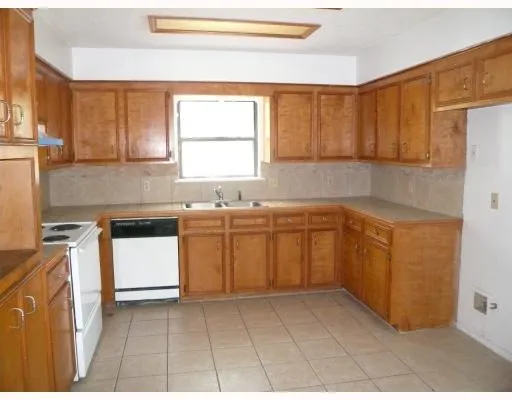 a kitchen with a sink window and cabinets