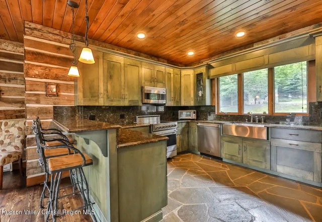 a kitchen with stainless steel appliances granite countertop a stove sink microwave and cabinets