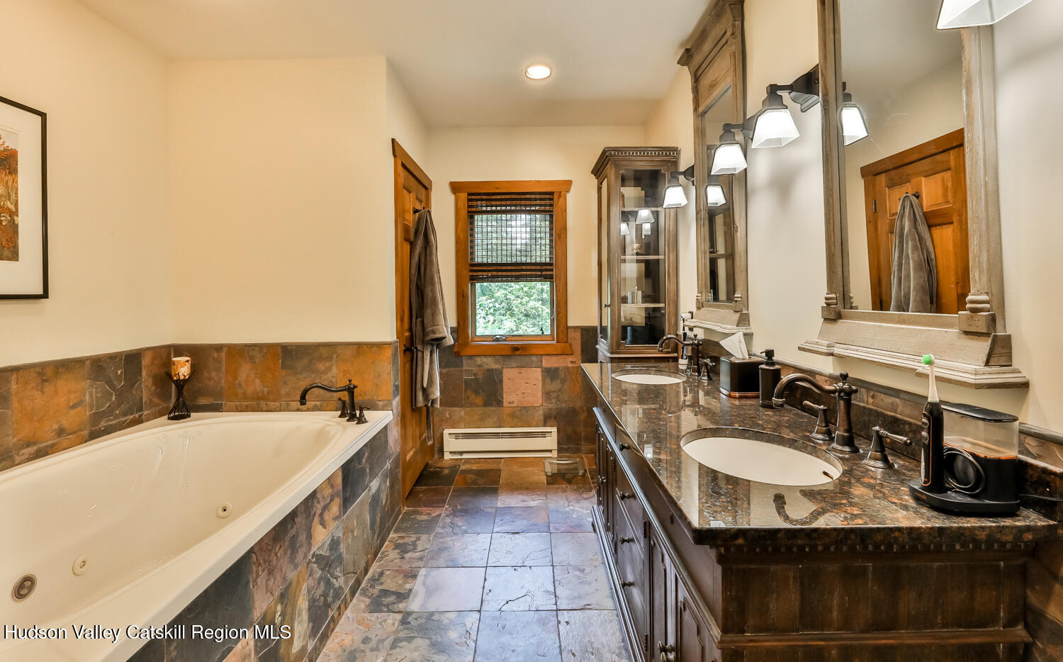 22 Club Road Windham, NY 12496 - Photo 27 of 41 a spacious bathroom with a granite countertop sink and a large mirror