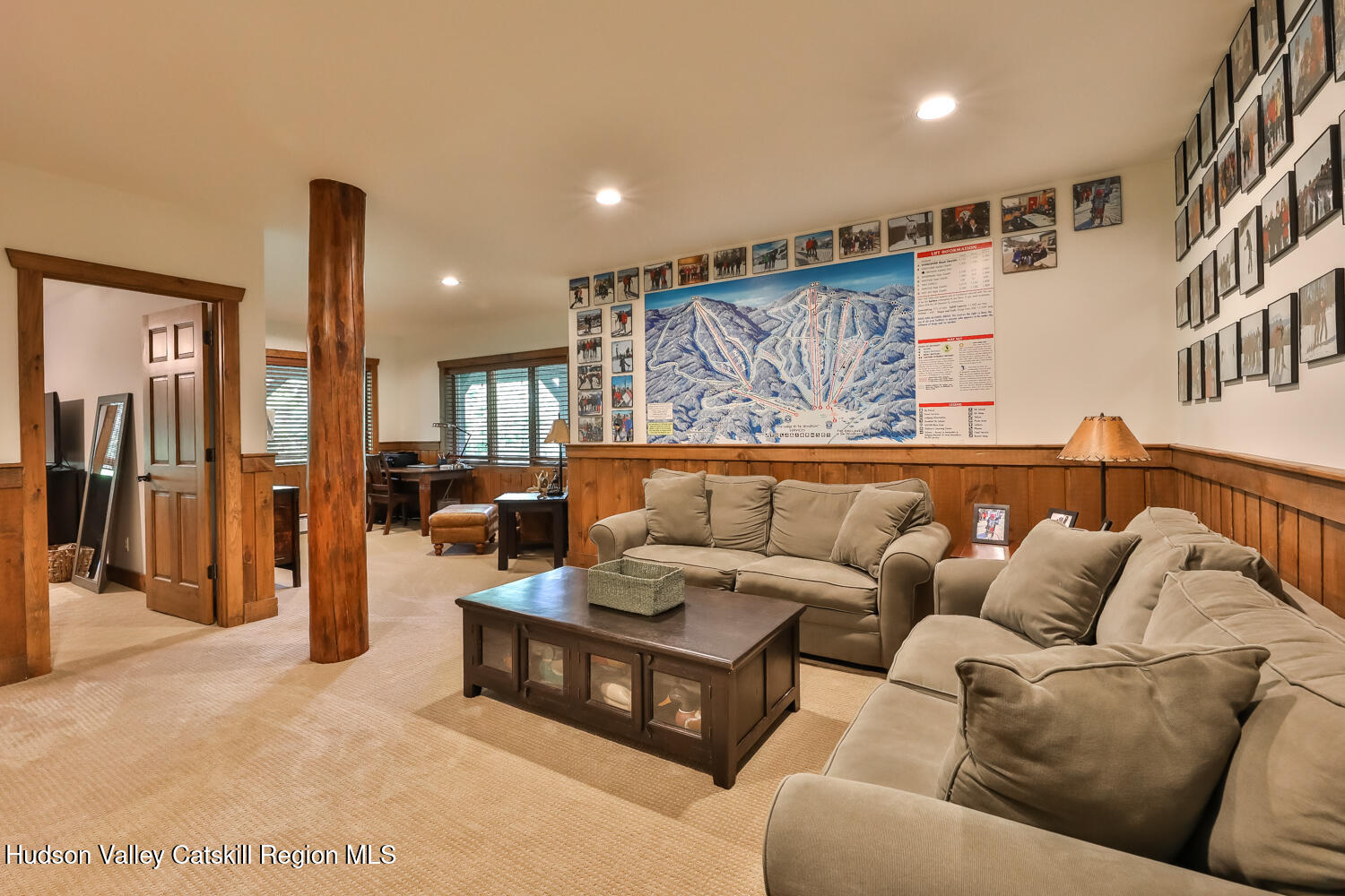 22 Club Road Windham, NY 12496 - Photo 32 of 41 a living room with furniture and a large mirror