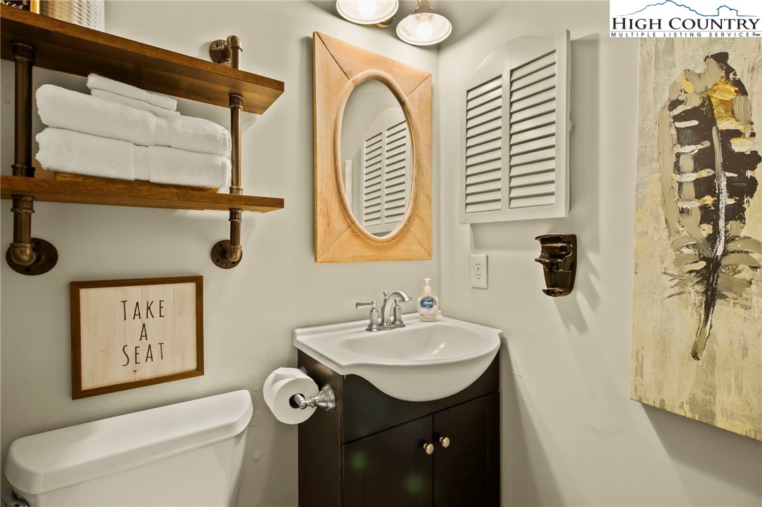 301 Pinnacle Inn Road, Unit 3301 Beech Mountain, NC 28604 - Photo 11 of 18 a bathroom with a toilet sink and mirror