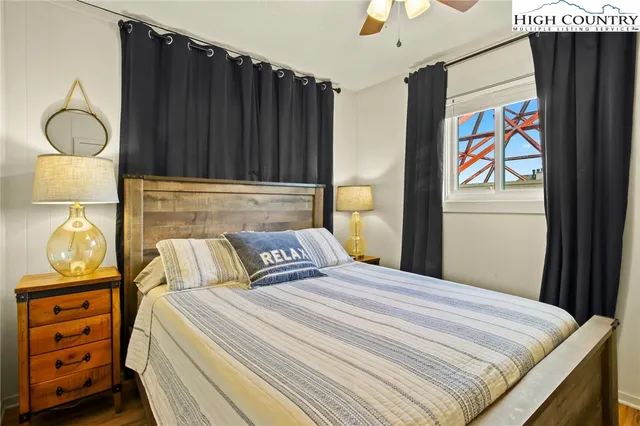 a bedroom with a bed and dresser with mirror