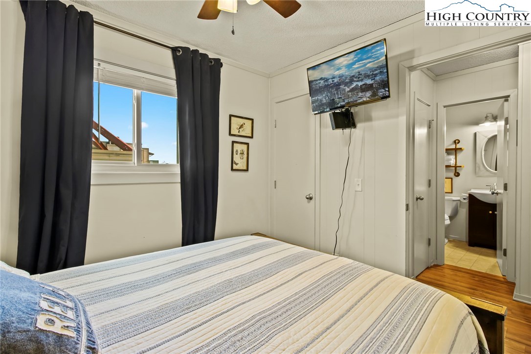 301 Pinnacle Inn Road, Unit 3301 Beech Mountain, NC 28604 - Photo 15 of 18 a bedroom with a bed and a chandelier