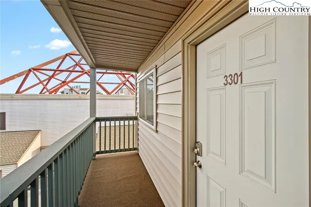 a view of a porch with wooden floor and stairs