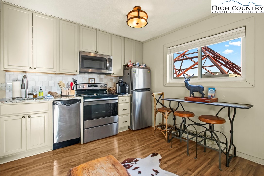 301 Pinnacle Inn Road, Unit 3301 Beech Mountain, NC 28604 - Photo 6 of 18 a kitchen with stainless steel appliances a stove a sink and a refrigerator