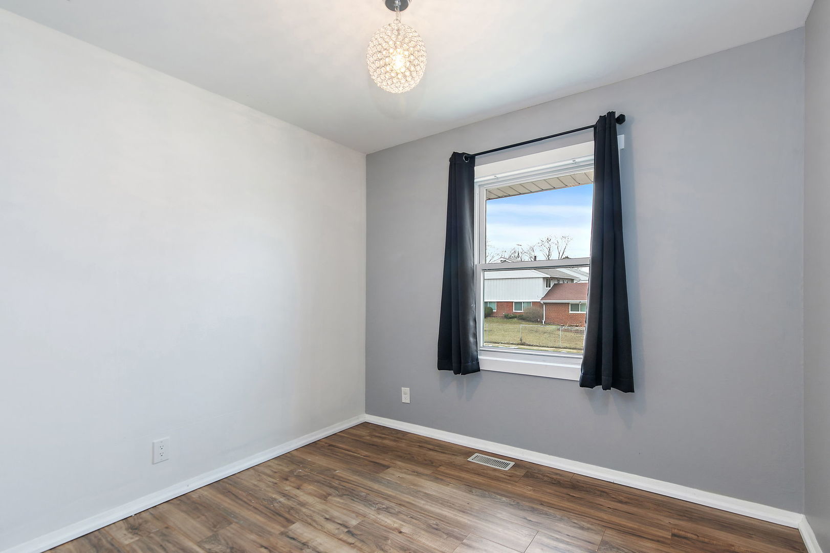 1014 Vine Street Streamwood, IL 60107 - Photo 12 of 23 an empty room with wooden floor and windows