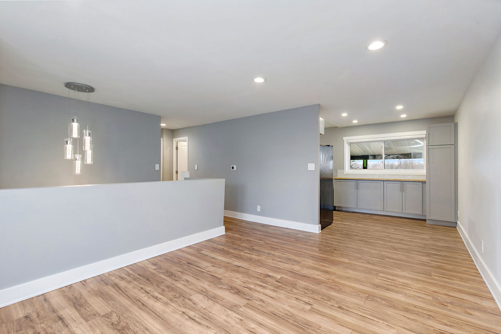 1014 Vine Street Streamwood, IL 60107 - Photo 4 of 23 a view of kitchen and empty room with wooden floor