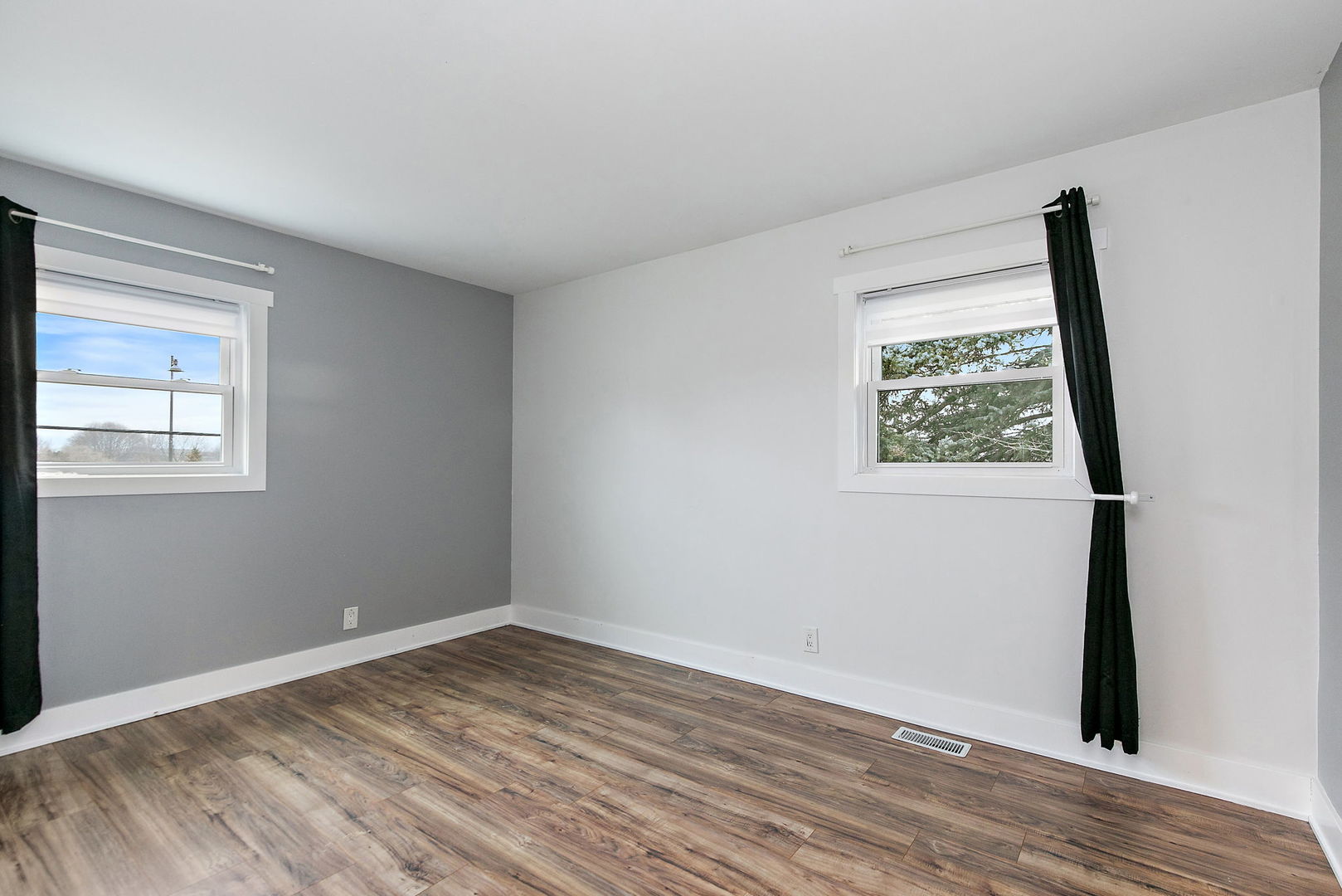 1014 Vine Street Streamwood, IL 60107 - Photo 10 of 23 a view of an empty room with wooden floor and a window