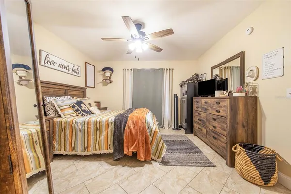 a bedroom with bed and a chandelier